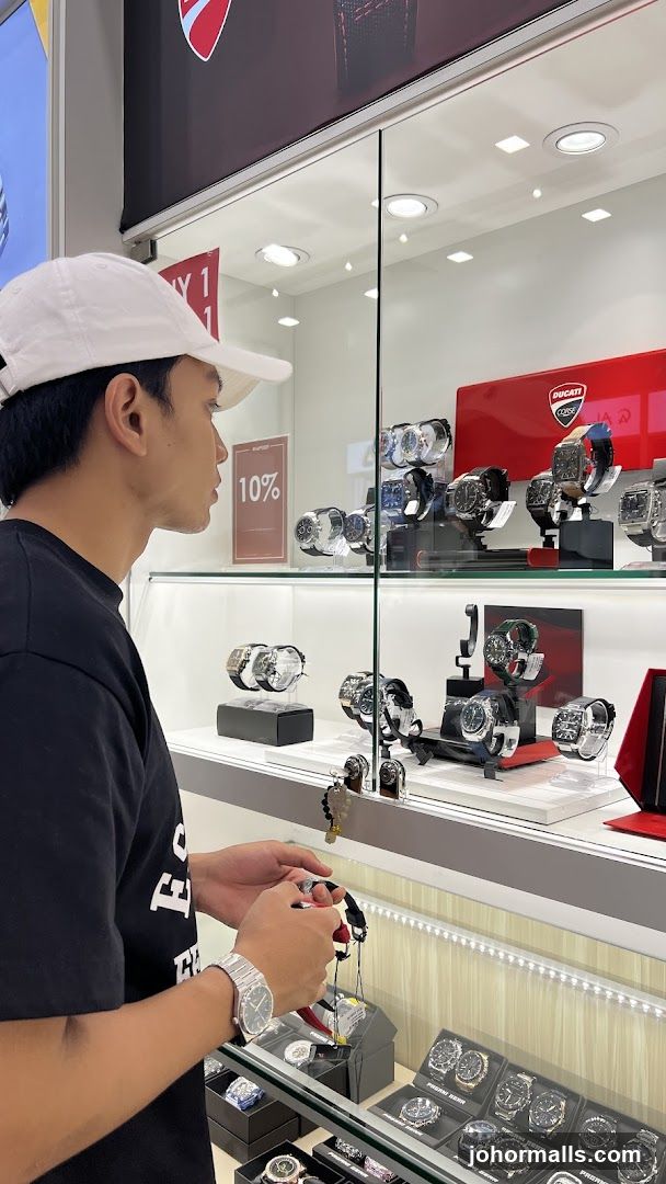 Man looking at watches in a display case