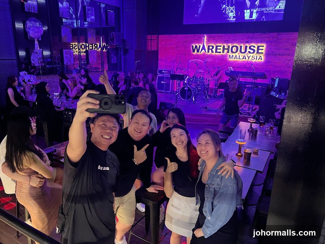People taking a selfie in a club with a stage