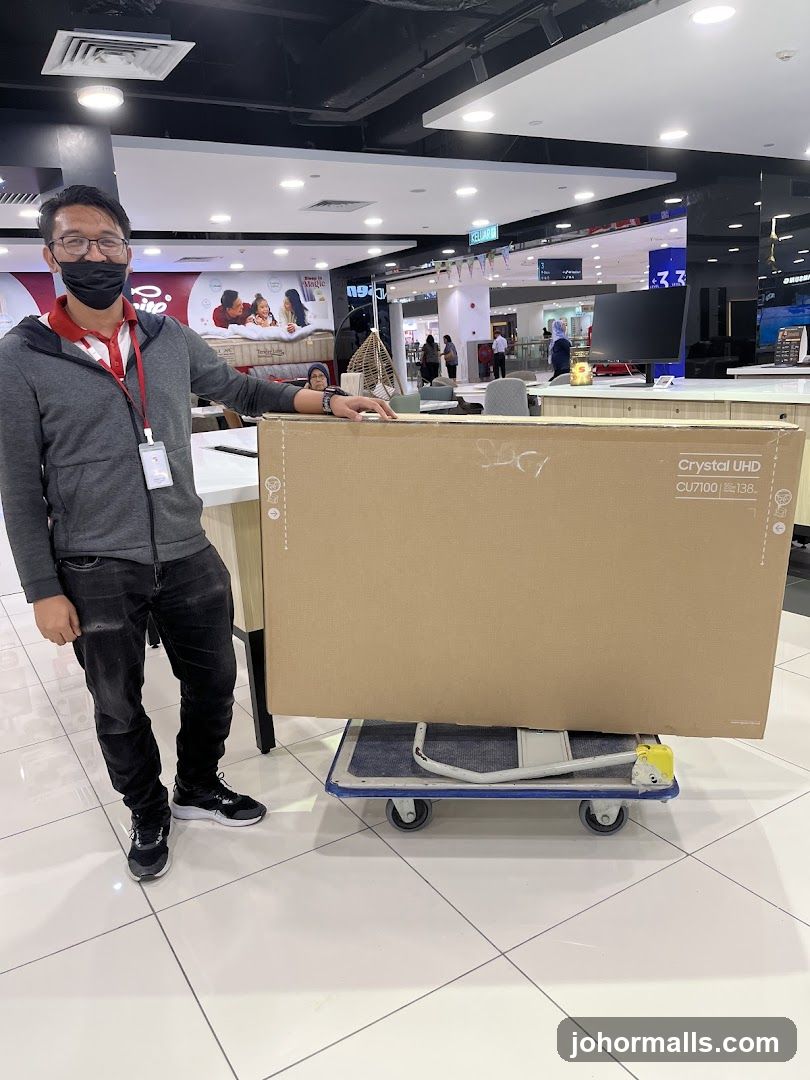 Man with a large TV box