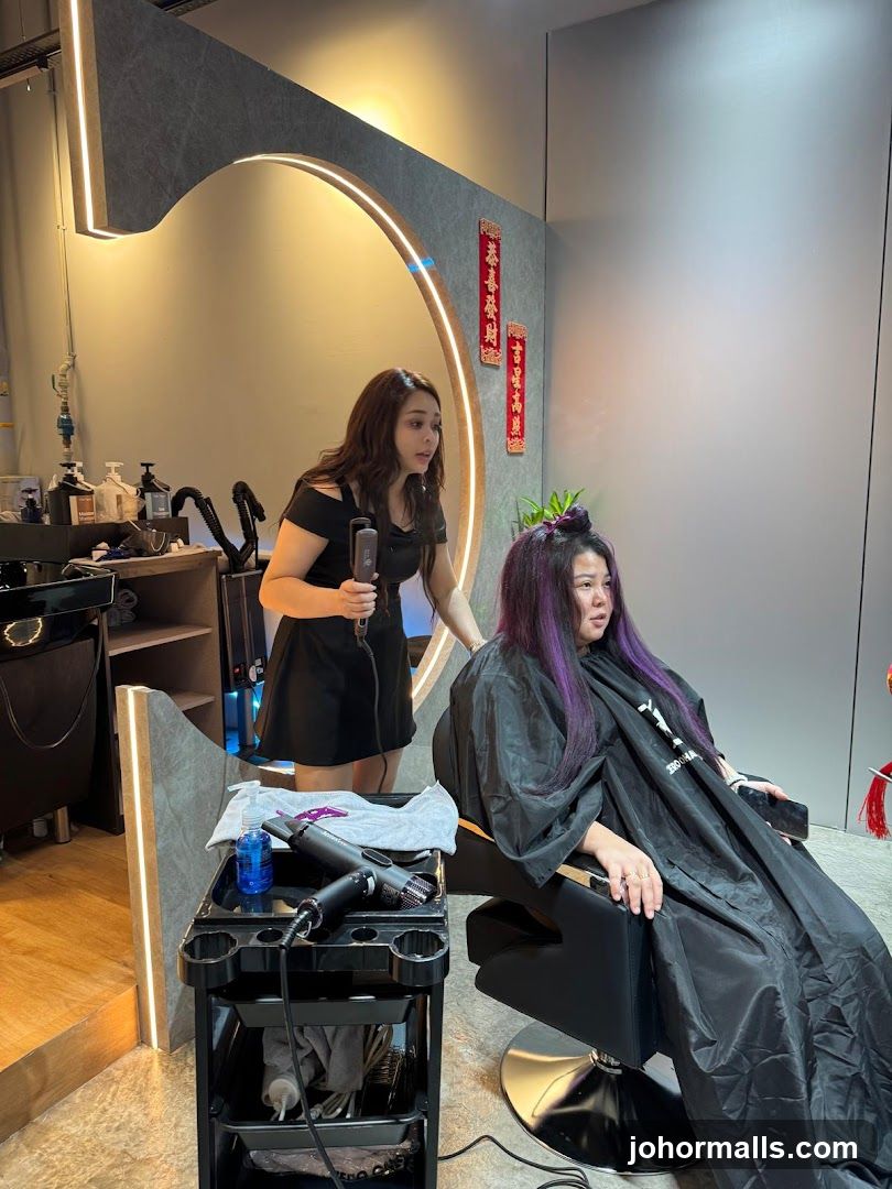 Hairdresser styling client's hair