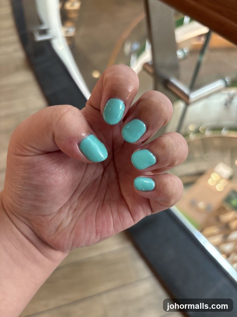 Close-up of a hand with turquoise nails