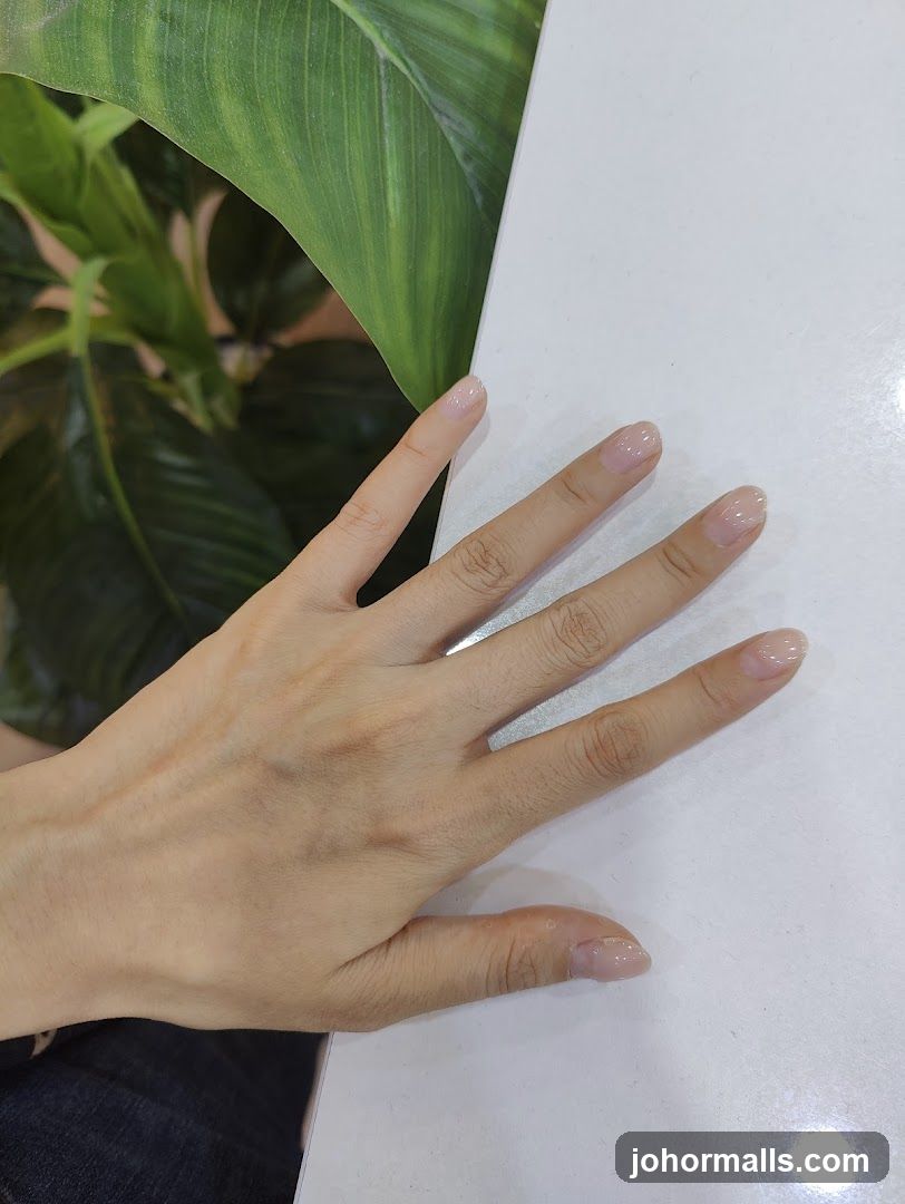 Hand with light pink nails