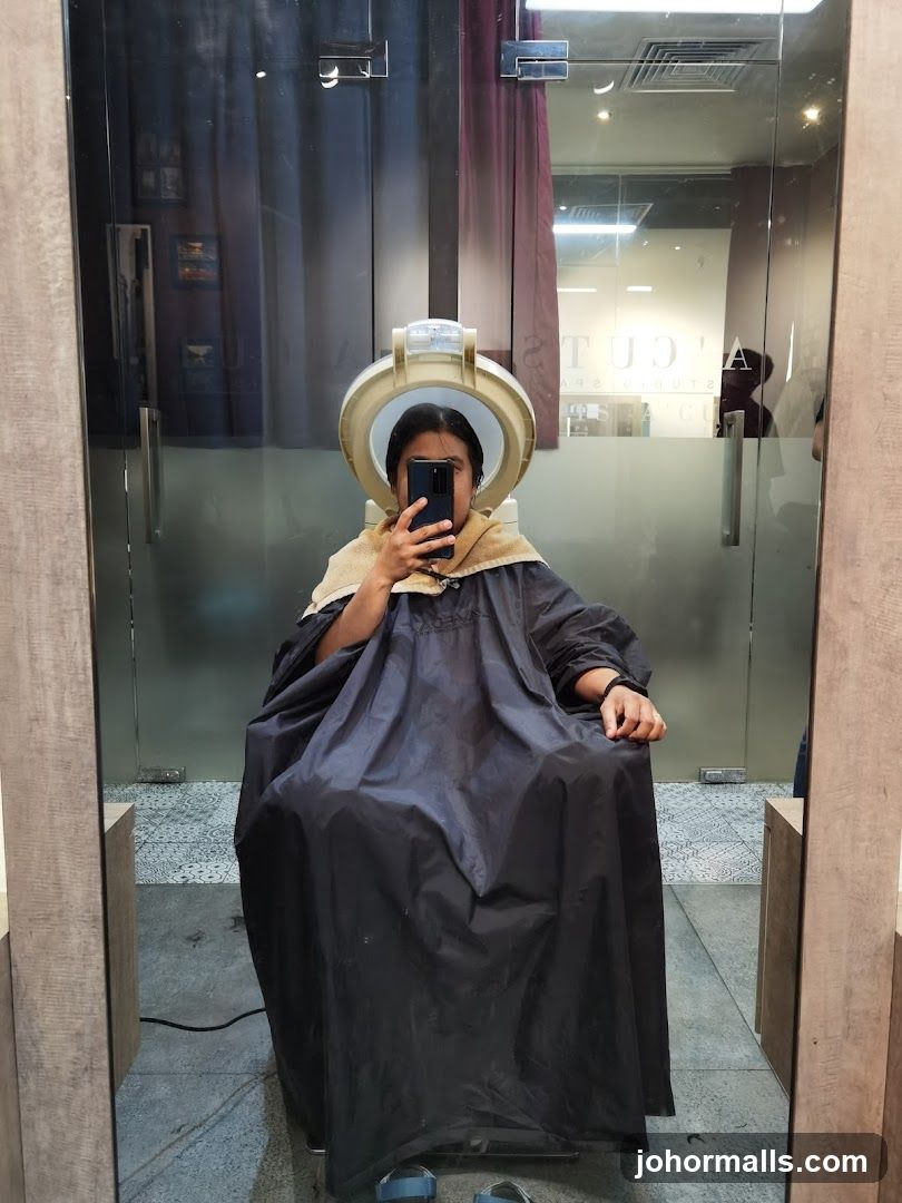 Woman under hair steamer
