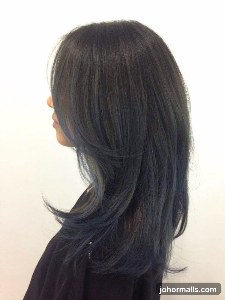 Woman with dark hair with blue highlights