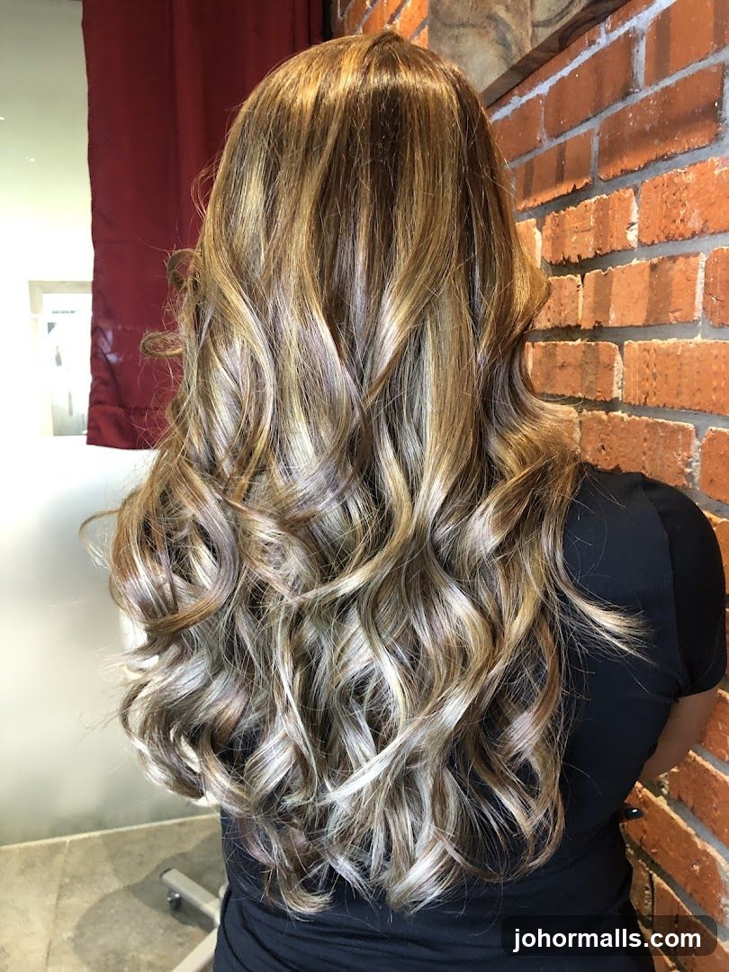 Woman with long, wavy, highlighted hair
