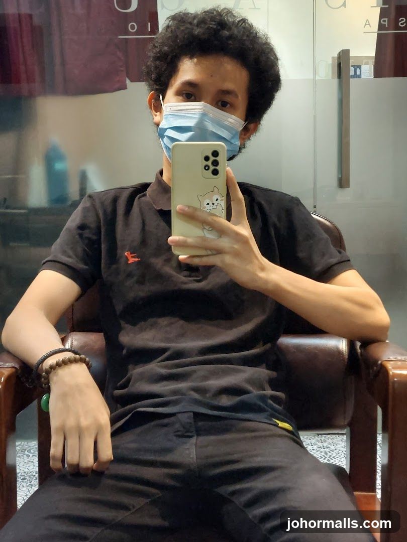 Man taking a selfie in a salon