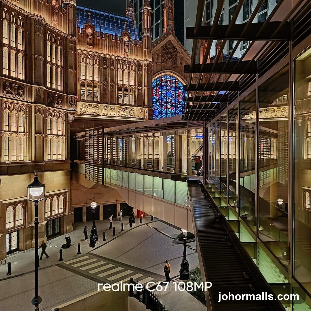 Night view of a modern building with a stained glass window and a skywalk
