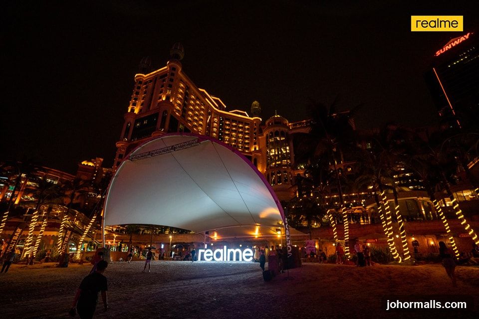 Outdoor event at night with illuminated building and signage