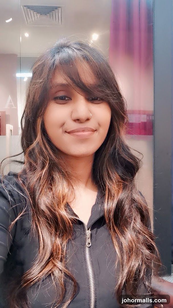Woman with long, wavy, highlighted hair
