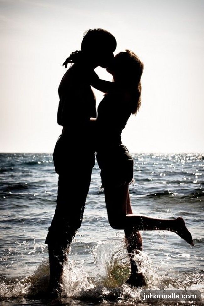 Couple kissing in the ocean