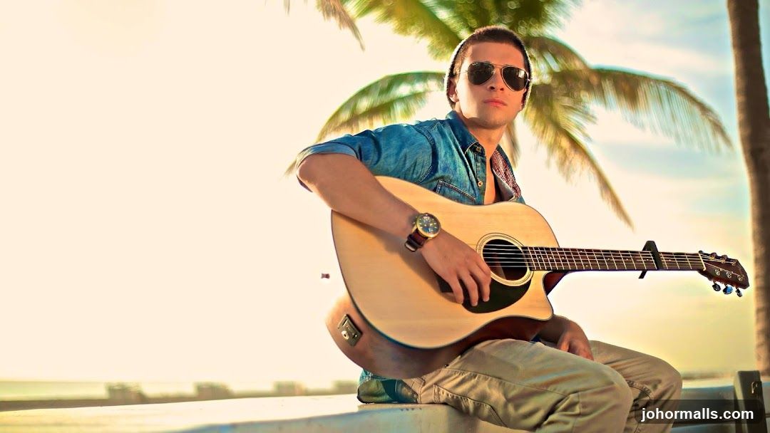 Man with Guitar on Beach