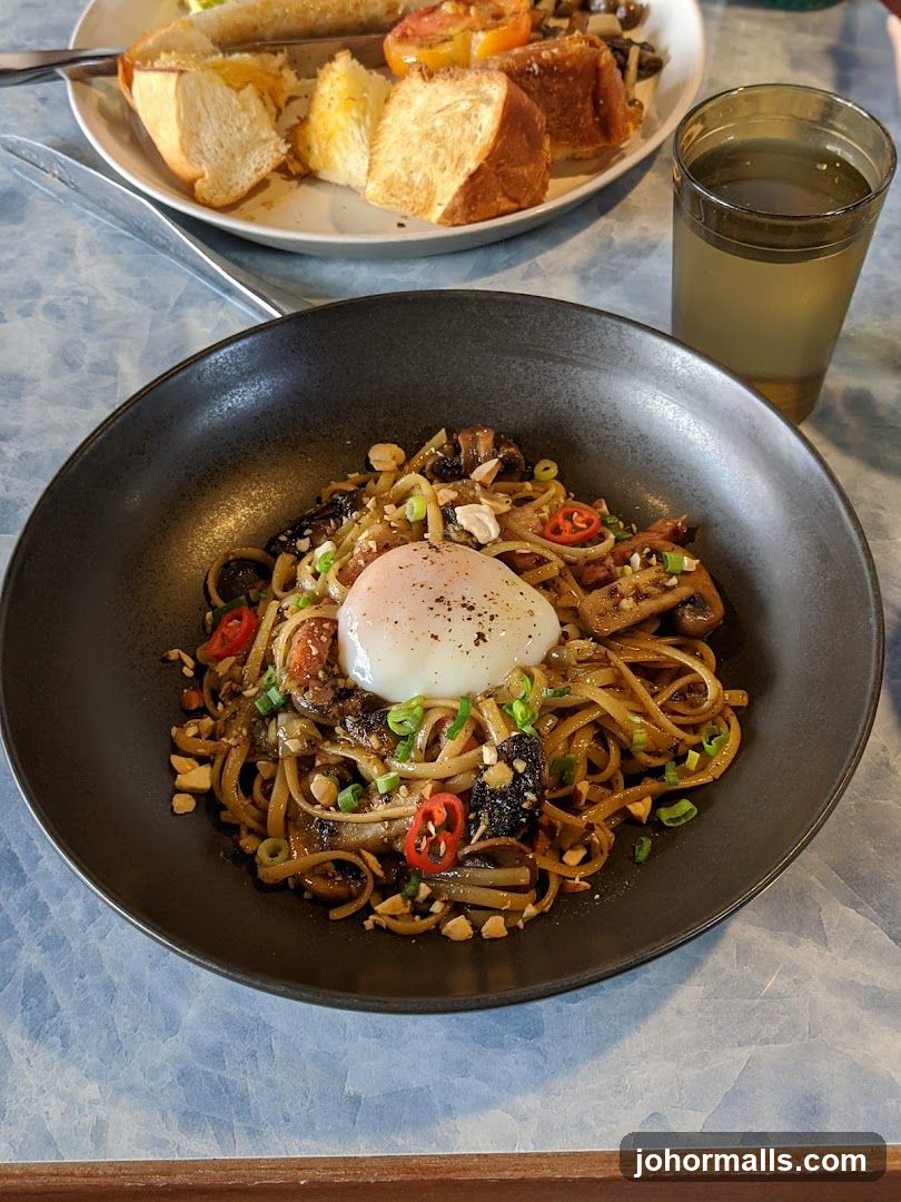 Noodle Dish with Poached Egg and Side of Toast