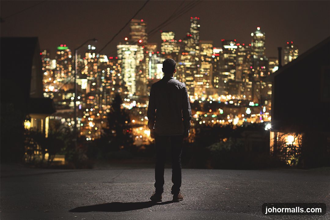 Man overlooking city at night