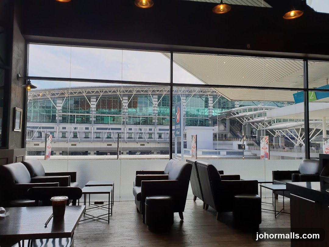 Interior seating area with a view of an airport terminal
