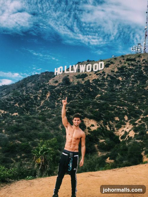 Man Posing in Front of Hollywood Sign