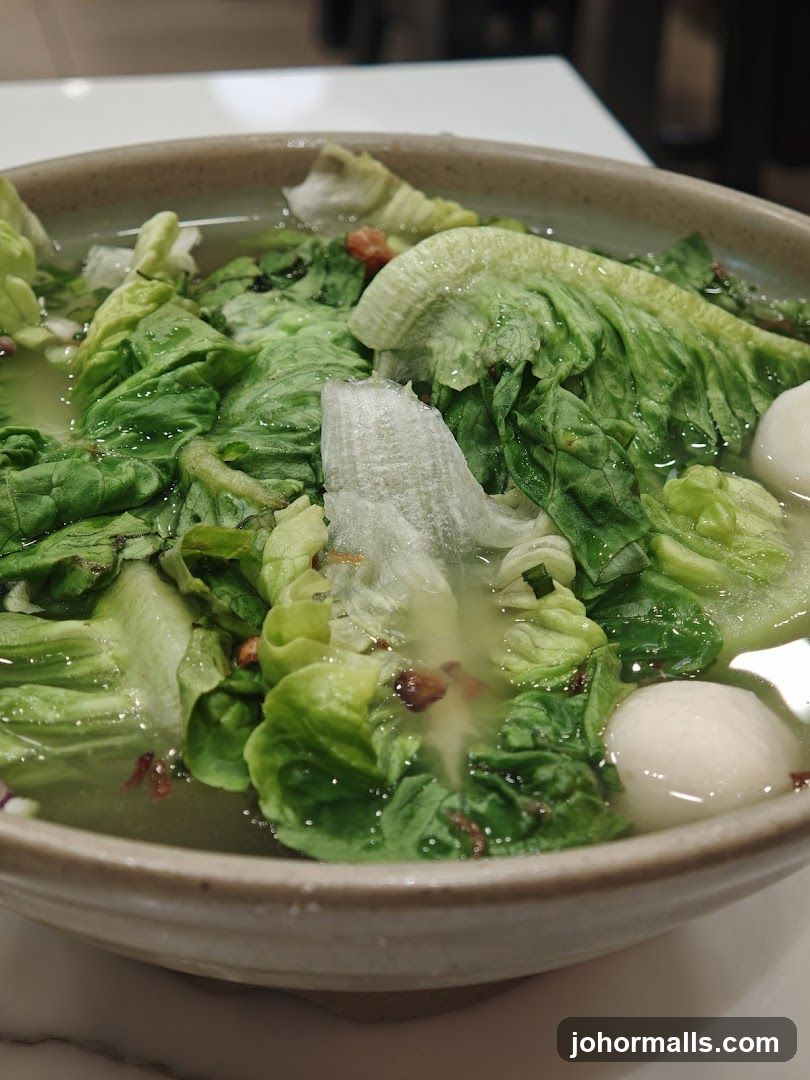 Bowl of Soup with Lettuce and Fish Balls