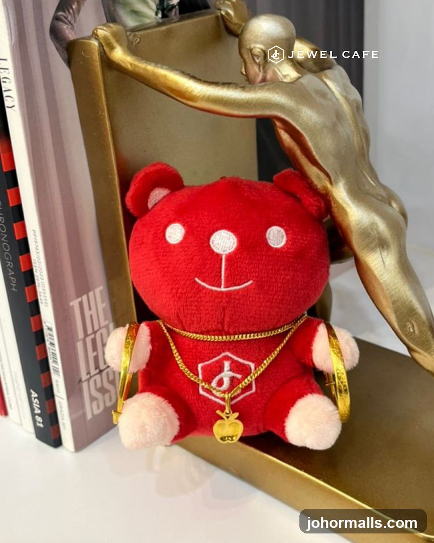 Red teddy bear with gold jewelry and books