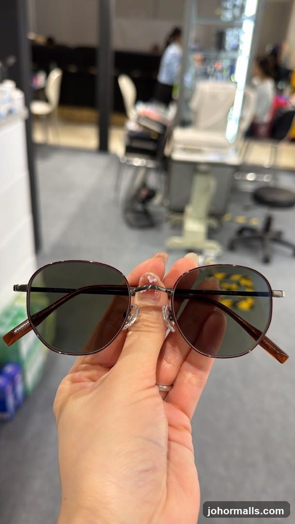 Person holding sunglasses
