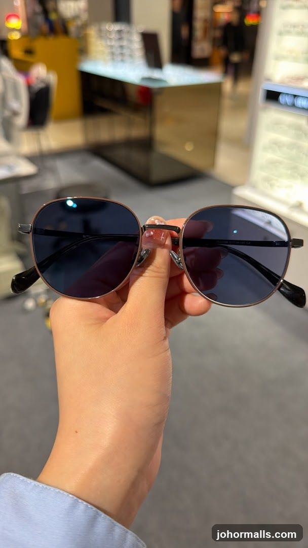 Person holding sunglasses