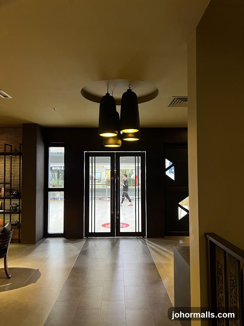 Interior view of a walkway leading to glass doors