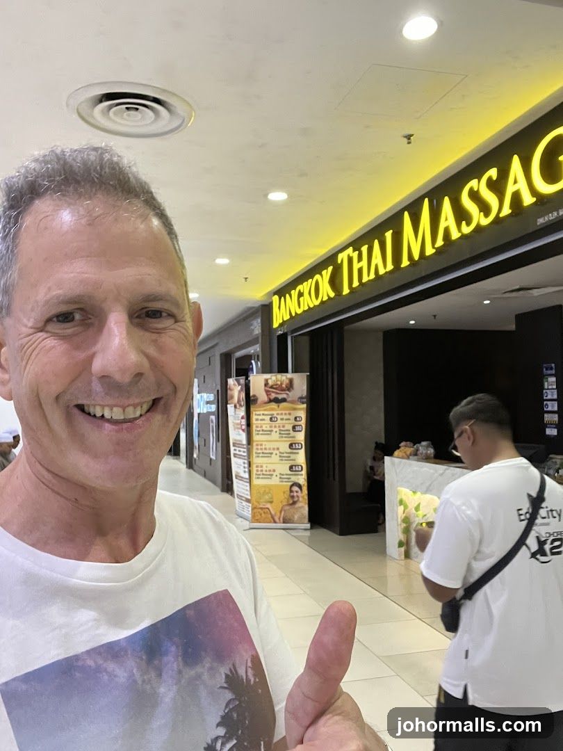 Man giving a thumbs up in front of a massage parlor
