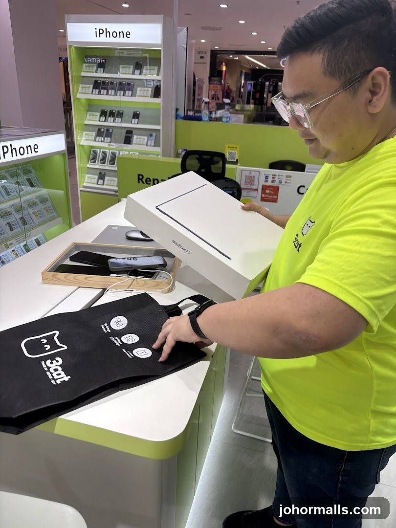 Man holding a MacBook Air box