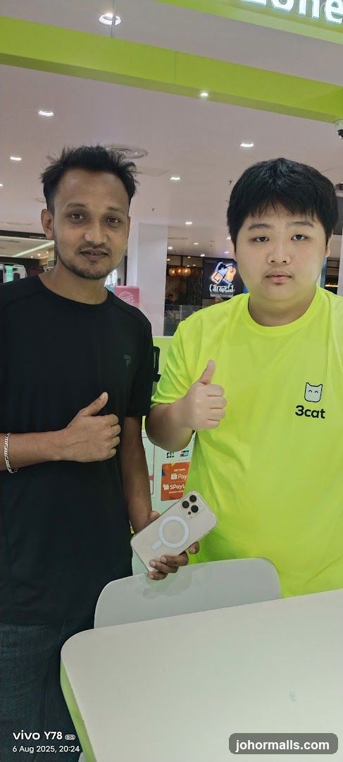 Two men posing with a phone