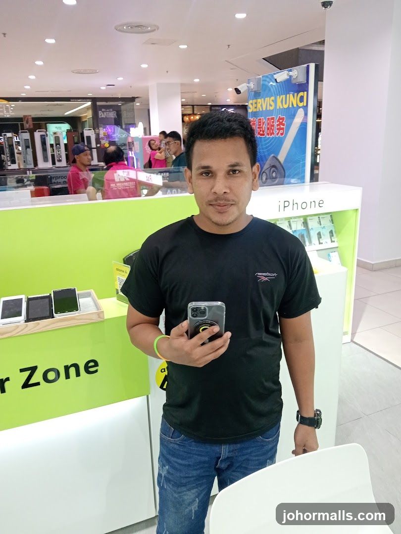 Man holding a smartphone in a store