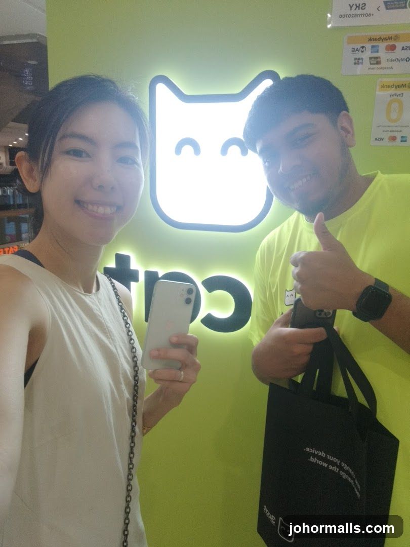 People Posing in Front of a Cat Logo