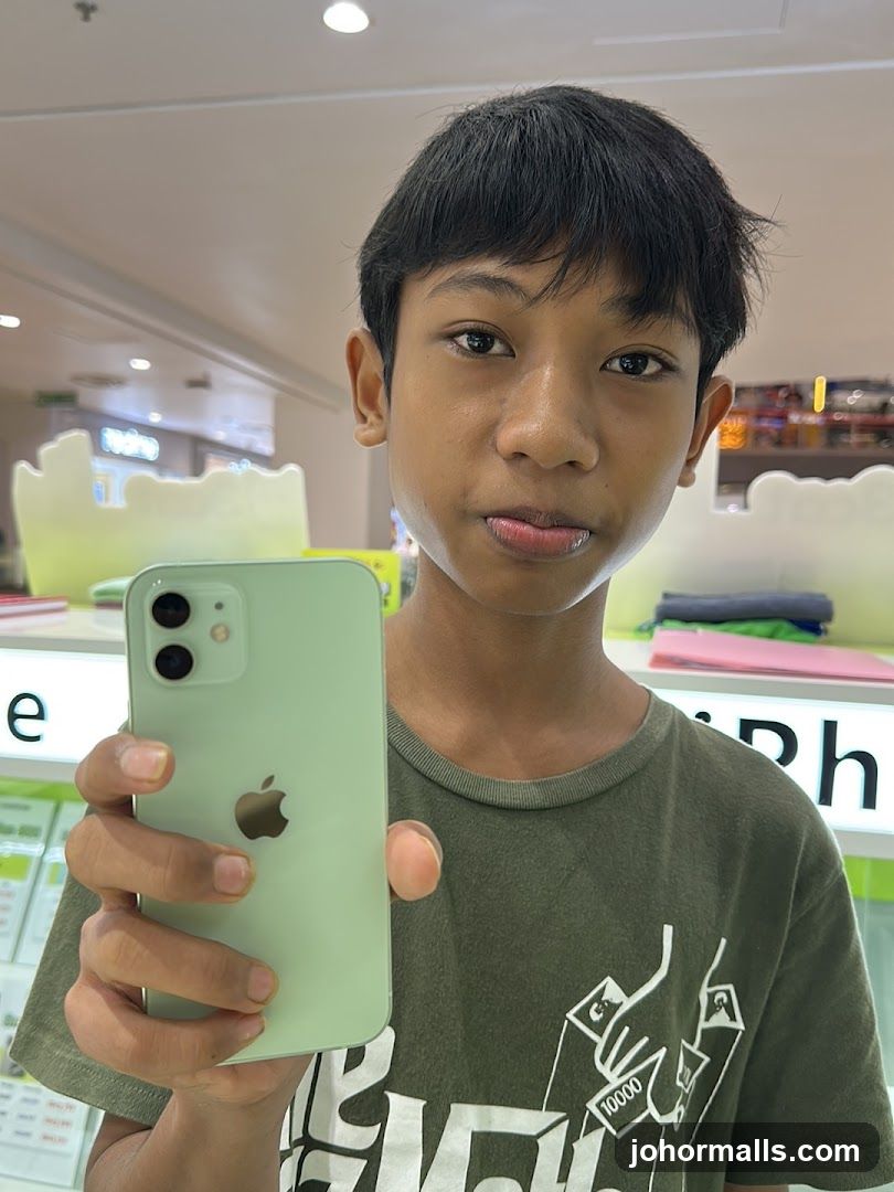 Young person holding a green iPhone