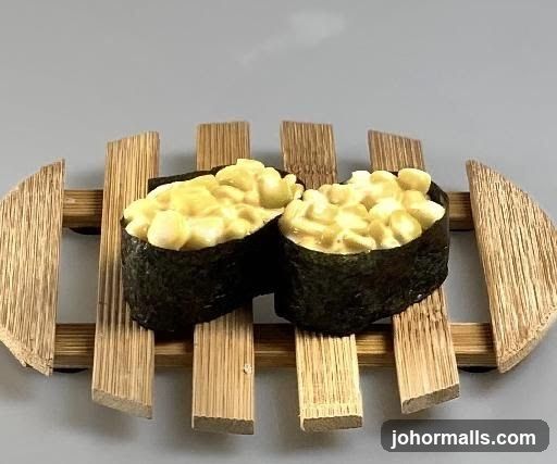 Two pieces of sushi on a bamboo stand