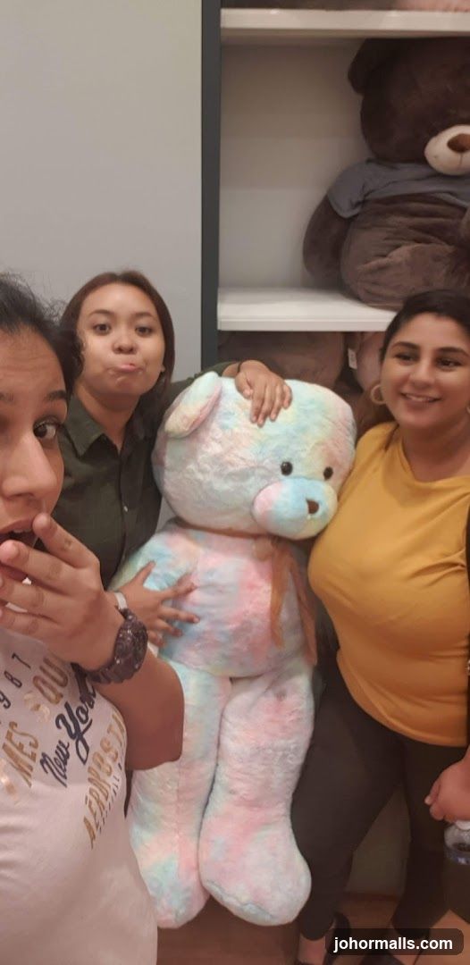 People with large teddy bears