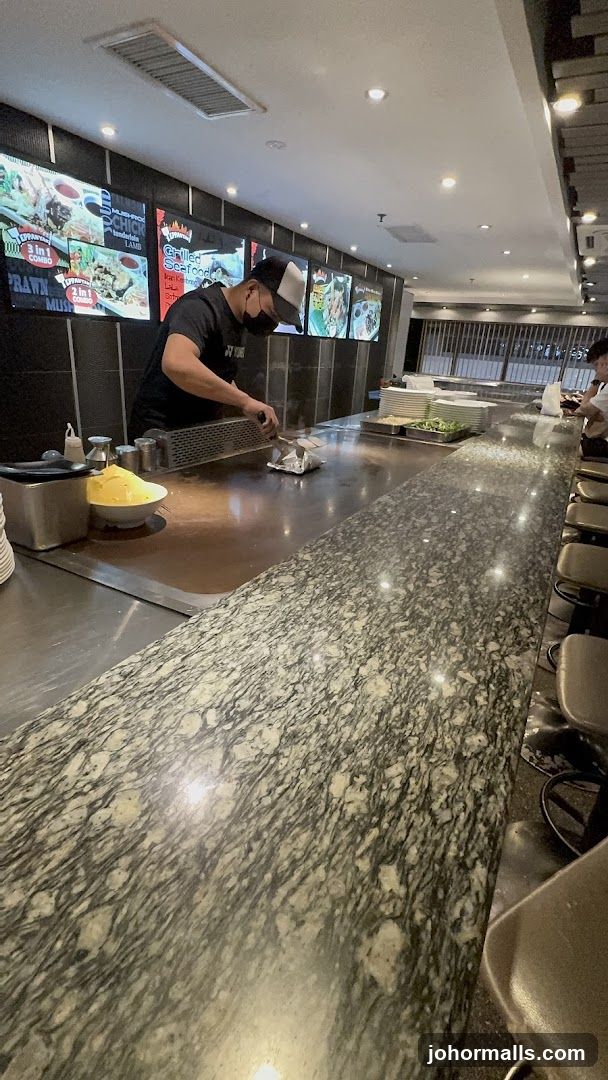 Chef cooking at a teppanyaki grill