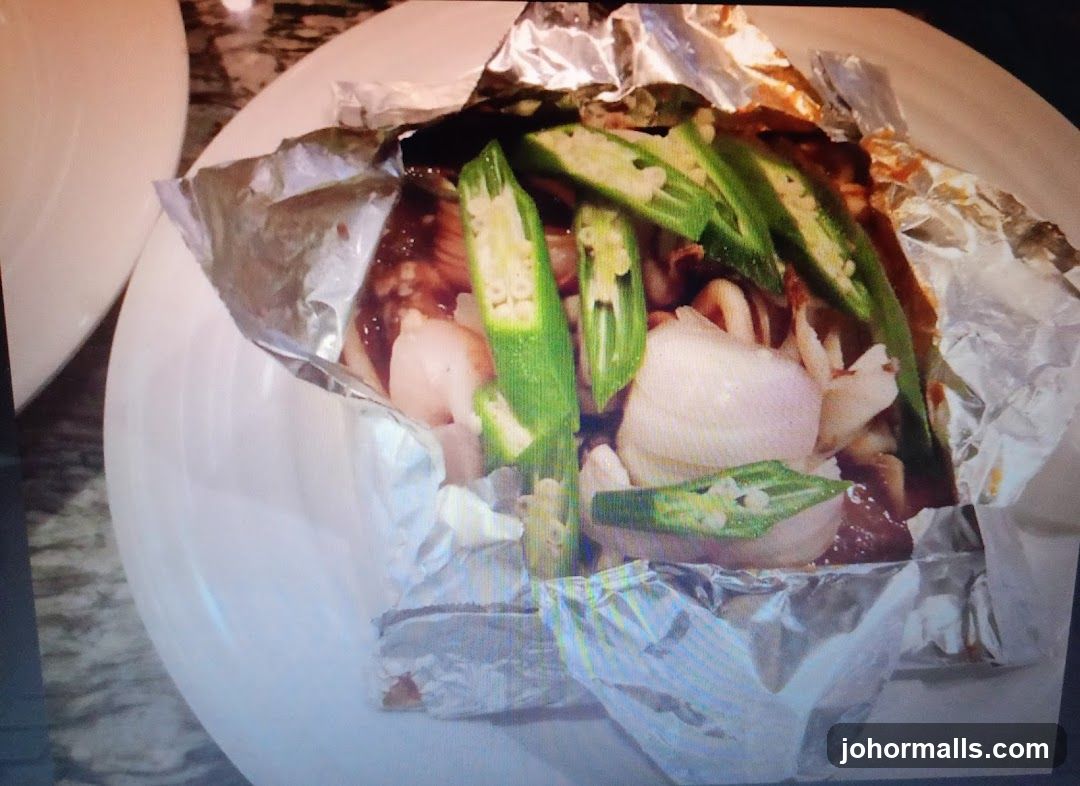 Foil-wrapped dish with okra and onions