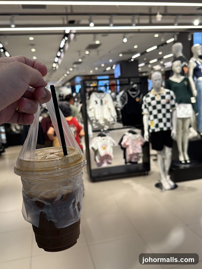 Person holding a coffee in a store