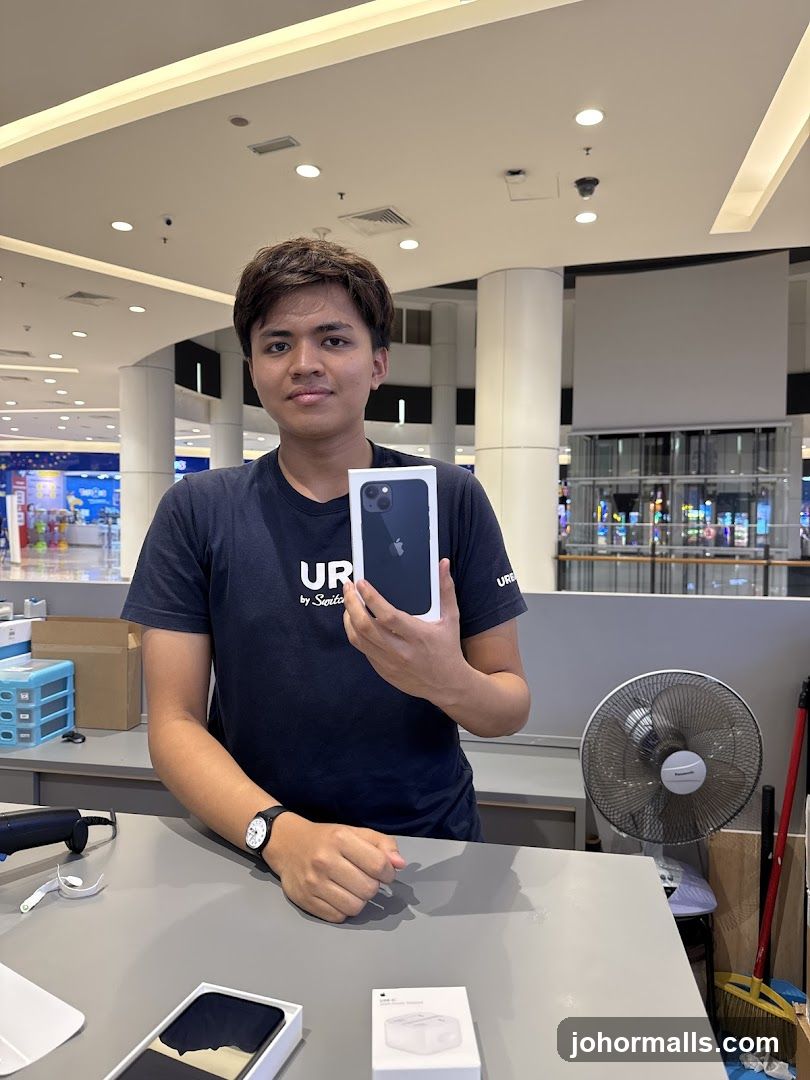 Man holding an iPhone box