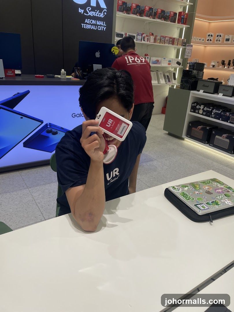 Person holding an ID badge in front of their face