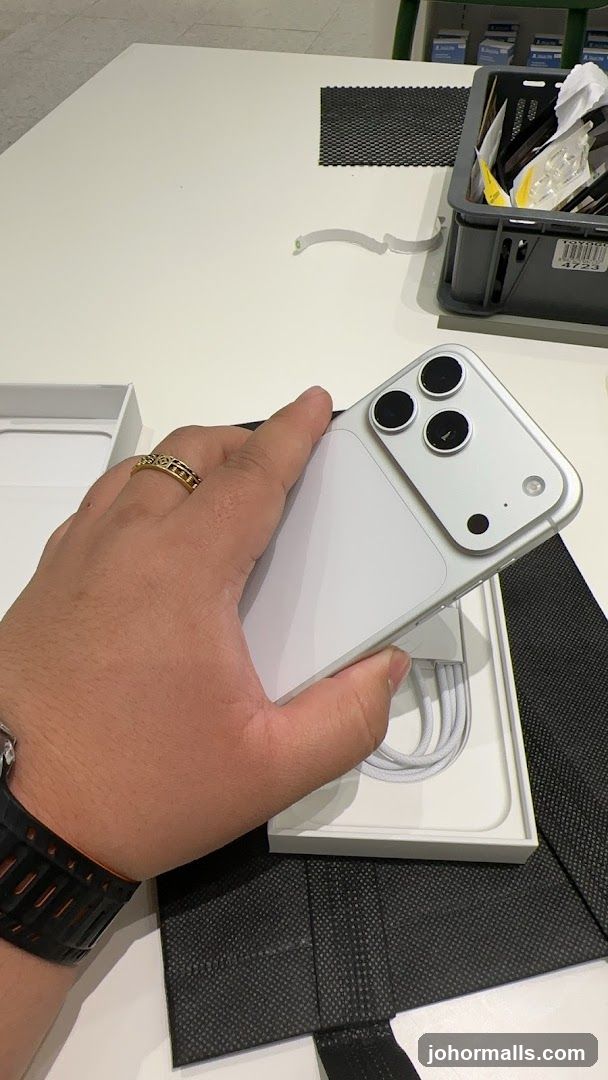 Hand holding a white smartphone