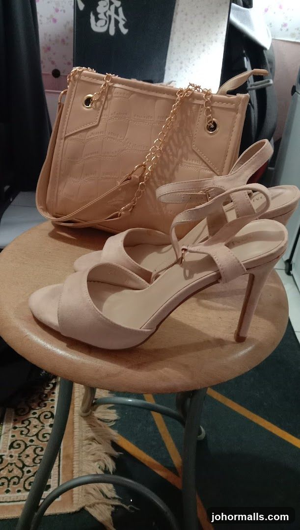 Beige handbag and heels on a stool