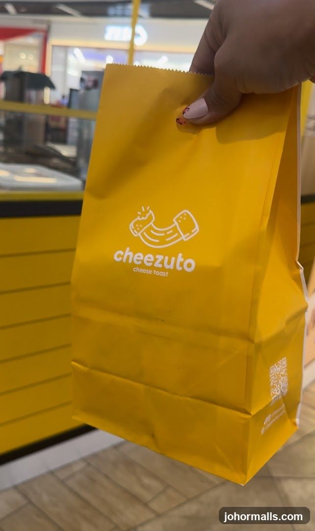 Yellow paper bag with "cheezuto cheese toast" logo