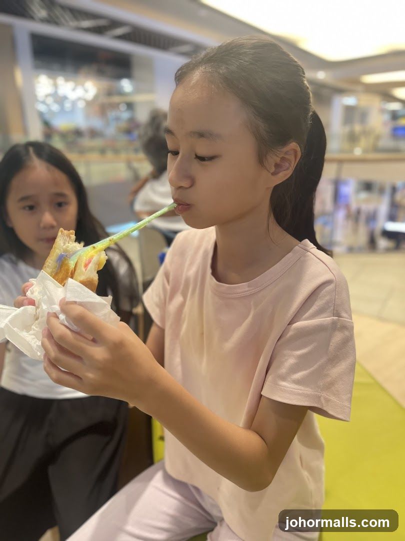 Children eating a colorful dessert