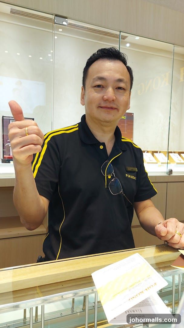 Man giving a thumbs up in a jewelry store