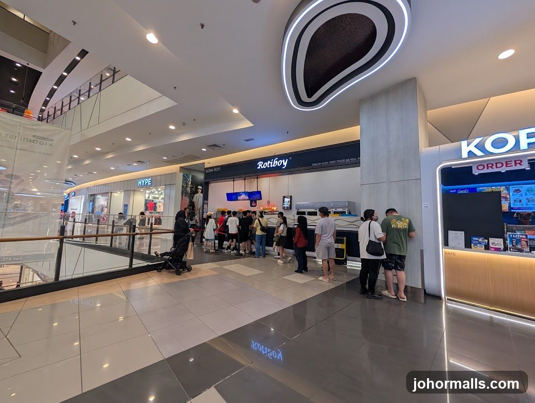 People queuing at a food stall in a mall