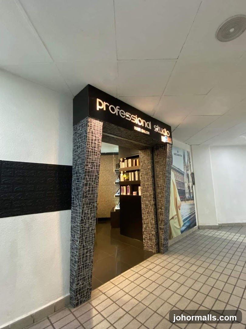 The entrance to a hair salon with a prominent sign reading "professional studio HAIR SALON" illuminated in gold lettering. The doorway is framed with a decorative pattern. Inside, shelves display various hair products. A large poster is visible on the right wall.