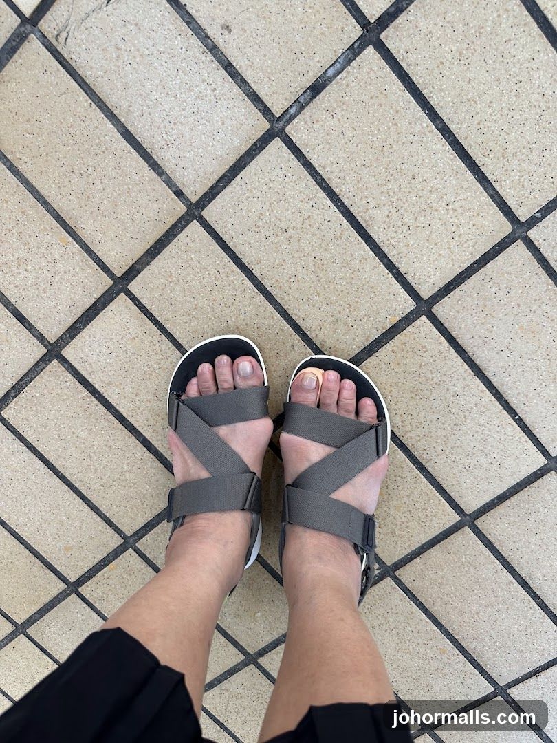 Feet in Sandals on Tiled Floor