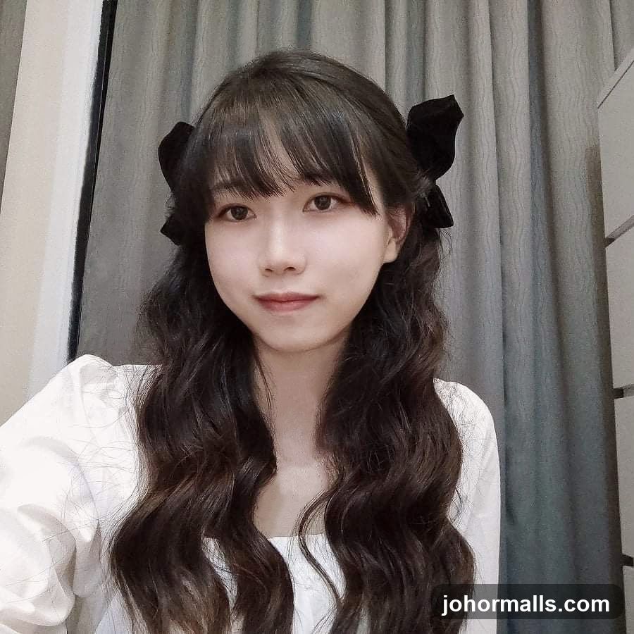 Young woman with dark wavy hair and bangs