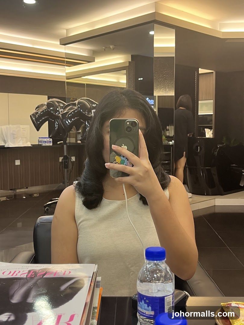 Woman taking a selfie in a salon