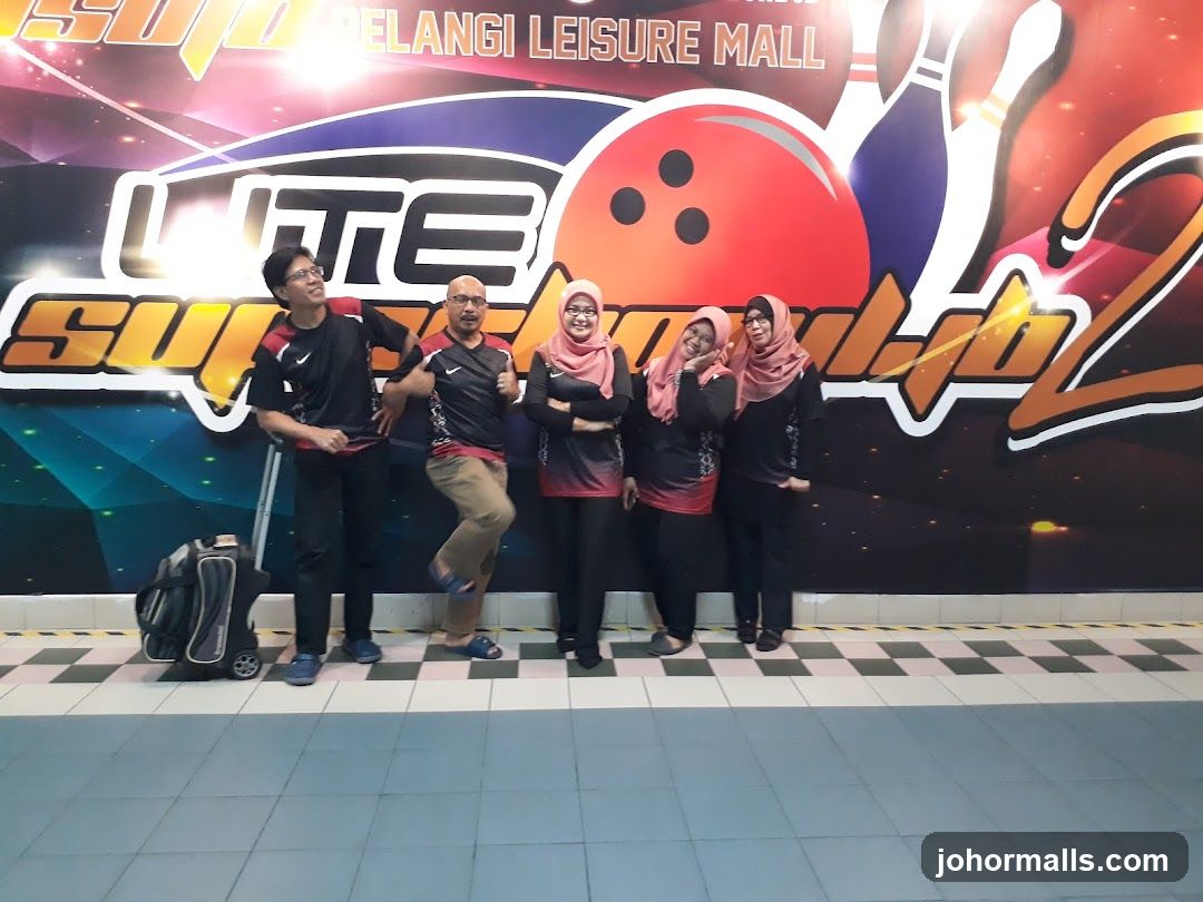 Group Posing in Front of Bowling Alley Mural