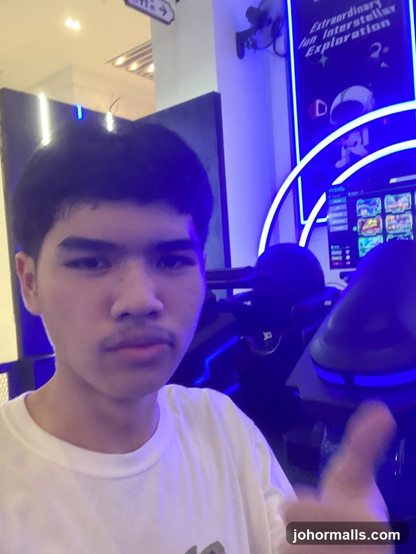 Man giving a thumbs up in an arcade