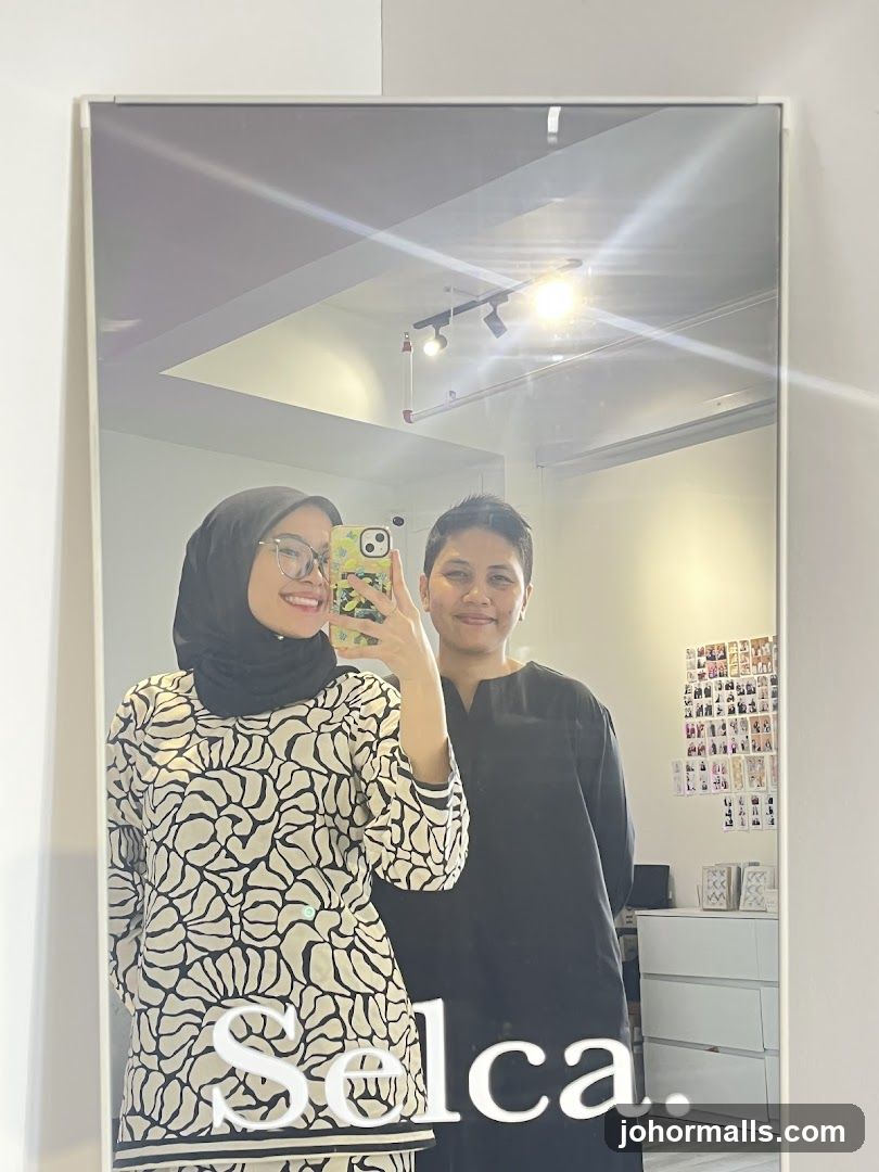 Two women taking a mirror selfie